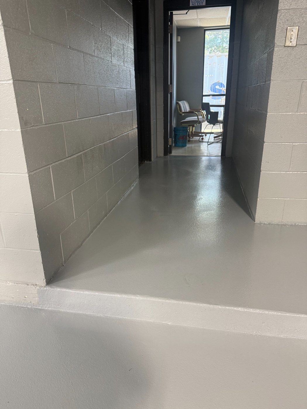 Finished epoxy broadcast floor in an Infinity dealer hallway
